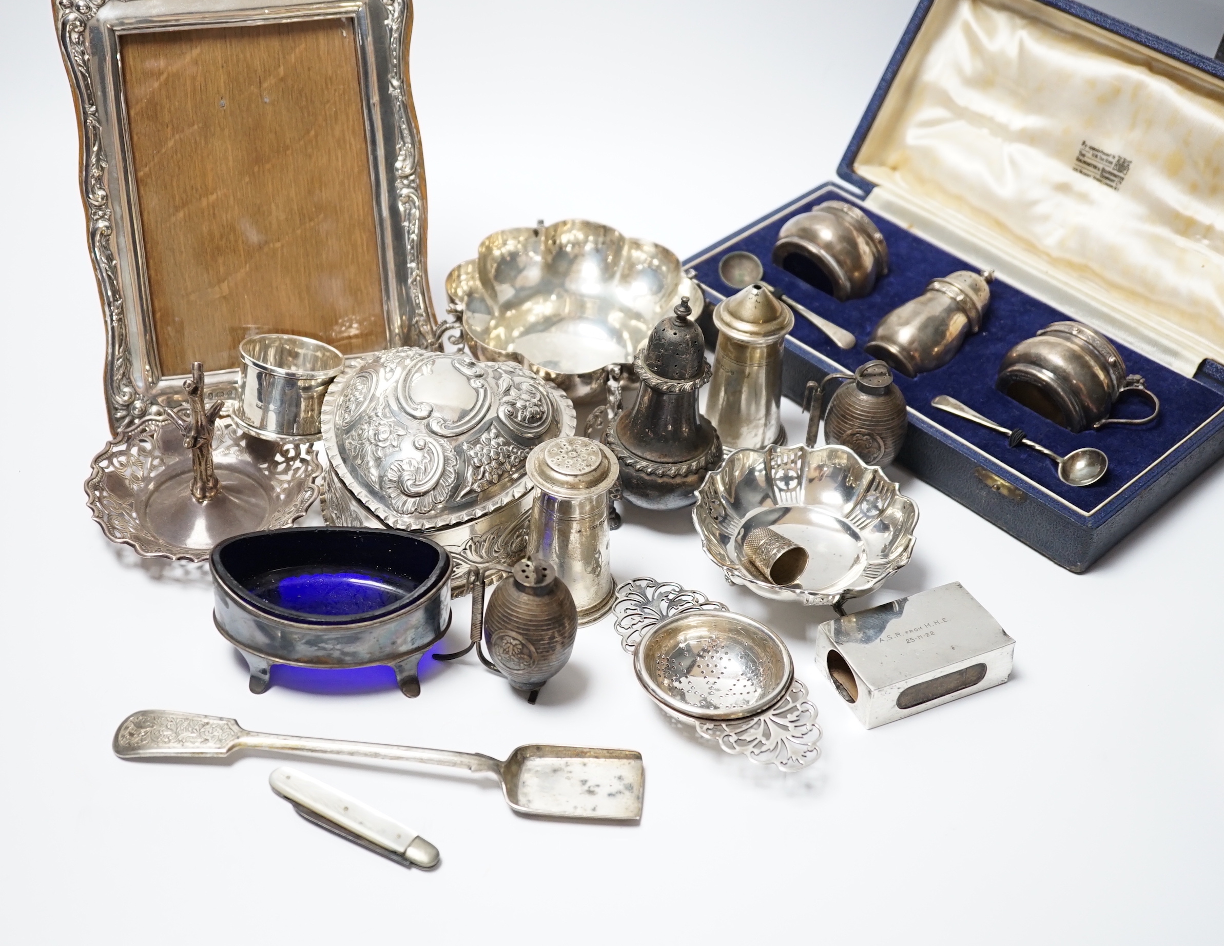 Sundry small silver including a repousse heart shaped trinket box, silver mounted photograph frame, dishes, ring tree, condiments including pair of Japanese sterling etc. and a plated stilton scoop.